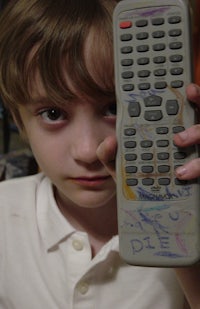 a boy holding a remote control